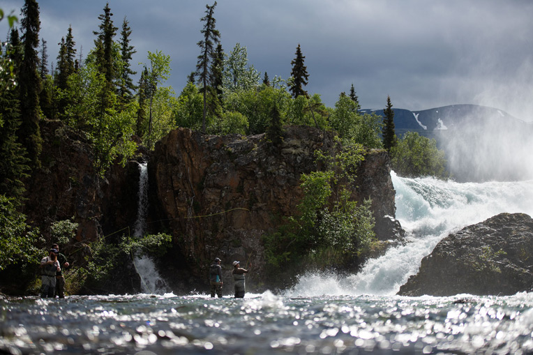 Military couples enjoy an afternoon fly fishing on the Tanalian River at the base of picturesque Tanalian Falls.