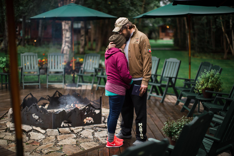 Navy Petty Officer 1st Class Mike Swanson and his wife Jessica share a moment at the Samaritan Lodge fireside.