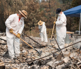 Volunteers help homeowners find valuables beneath the ashes after California wildfires burned homes.