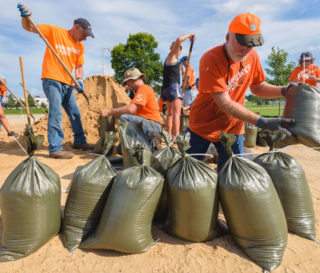 Samaritan's Purse volunteers work hard alongside community members to fill sandbags so that homeowners can use the bags to protect their property against rising floodwaters.