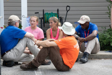 Homeowner Briton Wertz and her daughter Mia talk about Jesus with U.S. Disaster Relief volunteers and Billy Graham Rapid Response Team chaplains.
