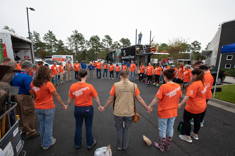 Samaritan's Purse volunteers pray before the day's work at our base in Wilmington, Port City Community Church.