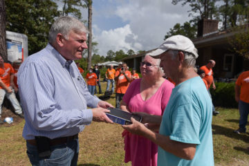 Franklin Graham presented a signed Bible to homeowners Bill and Charlene White.