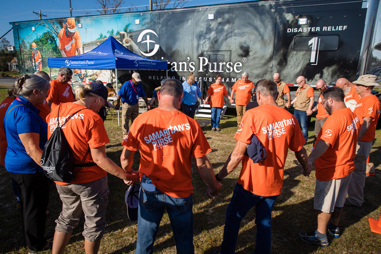 Samaritan's Purse volunteers and Billy Graham Rapid Response Team chaplains pray before work in the Florida Panhandle.