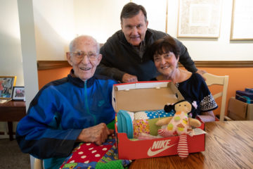 Theron and his daughter and son-in-law, Debbie and Bob Whattoff, can make even quilts fit in shoebox gifts!