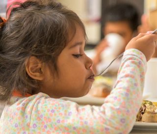 A young girl has a hearty meal at our shelter in Bucaramanga.