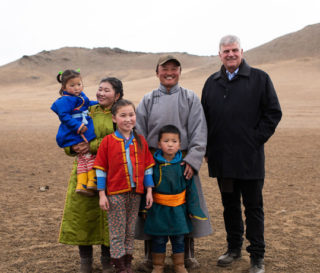 Franklin Graham meets in the grasslands of Mongolia's Tuv Province with the family of a Children's Heart Project beneficiary.