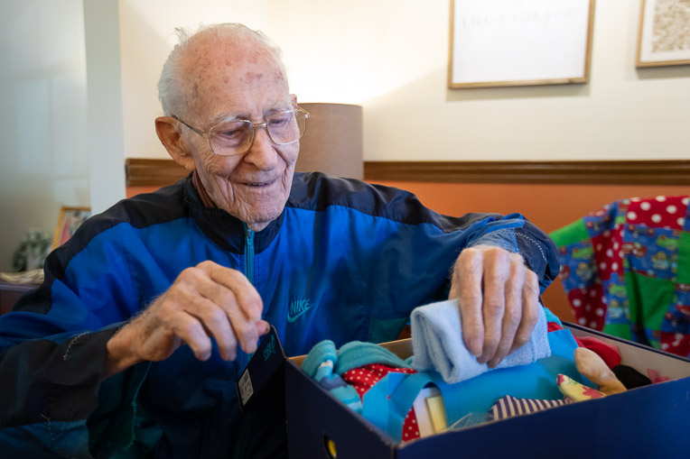 Theron Jennings, 98, looks through quilts he's made for Operation Christmas Child.