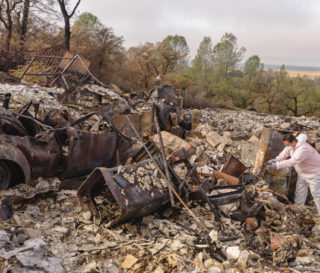 A volunteer searches the Mannion property for valuables.