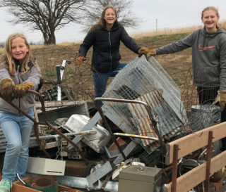 Naomi, Claira, and Hope Dannefer are blessing people in need by giving through the Samaritan's Purse gift catalog. Claira, right, collected and sold scrap metal to raise money for projects such as cleft lip and cataract surgeries, water filters, dairy goats, and blankets.