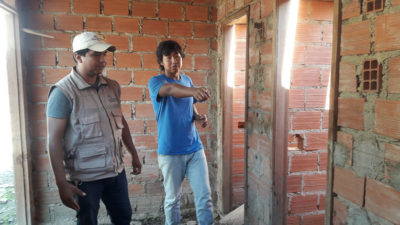 Wilfredo and Raul Salvatierra, head of our water, sanitation, and hygiene projects in Bolivia, review construction plans for the school's new restroom facility. 