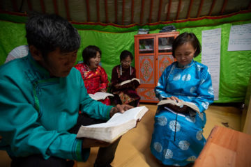 A church in Batnorov, Mongolia, that was planted in part through shoebox gifts meets in their yurt for a prayer meeting.