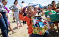 Six-year-old Khosoo delights to find a journal amid all the treasures in his shoebox gift.