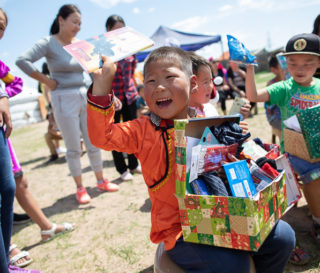 Six-year-old Khosoo delights to find a journal amid all the treasures in his shoebox gift.