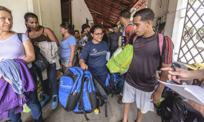 Viviana Paez distributes backpacks to Venezuelans migrants in La Don Juana, Colombia.