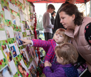 Bake sale shoppers make a donation to the gift of their choice in the Samaritan's Purse Christmas catalog. The Buttles creatively display all 42 gift items on this large board.