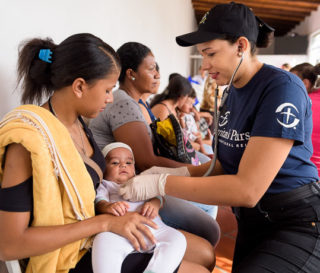 Nurse/chaplain Liyineth Espejo examines a patient at the Center of Hope in Cucuta, Colombia.