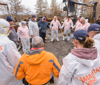 Samaritan's Purse disaster relief volunteers pray with a homeowner in Paradise, California.