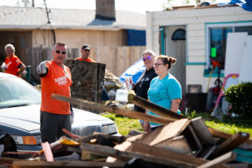 Glenn (left) discusses the debris removal with Kara and her friend Heather.
