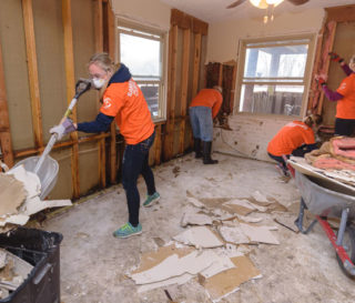 Samaritan's Purse volunteers remove damaged sheetrock and drywall from a flooded home in Dodge County.