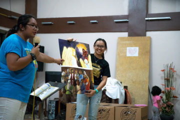 Wren, right, helped with the Gospel presentation during the shoebox distribution at Cornerstone. 
