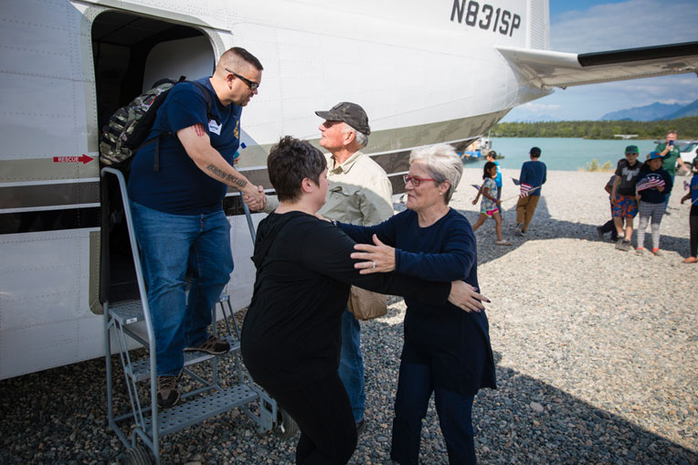 Franklin and Jane Graham greet Army Staff Sgt. Jarrod Stover and his wife Kristi as they arrive at Samaritan Lodge Alaska for a week of Biblically based marriage enrichment.