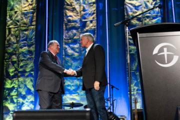 Franklin Graham and former Arkansas Governor Mike Huckabee greet at the Prescription for Renewal conference where Huckabee addressed doctors, nurses, and other medical professionals.
