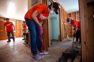 Volunteers on Ocracoke work to remove flooring after flooding from Hurricane Dorian.