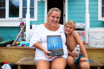 Rachel O'Neal and her son Austin received a special Bible after volunteers worked on their home.
