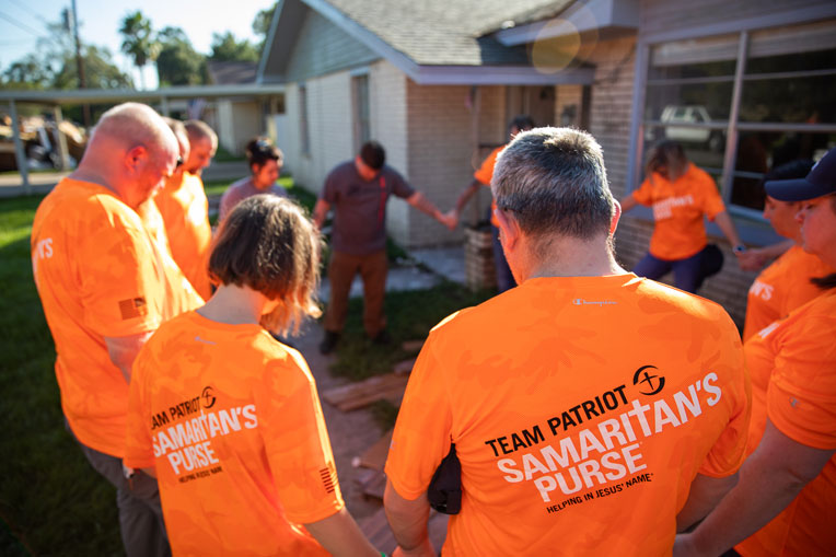 Team Patriot volunteers pray with homeowners in Texas.