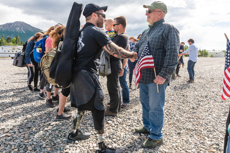 JP Lane, a medically retired Army veteran, greets a Port Alsworth community member after arriving at Samaritan Lodge Alaska.