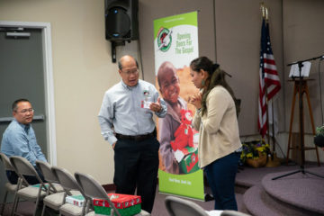Manny Ma speaks with Operation Christmas Child volunteer Kim Vance who received a shoebox gift as a child in Southeast Asia and shared her story with members of the Boise Chinese Christian Church.
