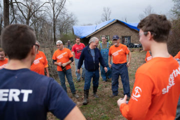 Don Breshears thanks volunteers who helped him clear his yard and place tarp on his damaged roof.