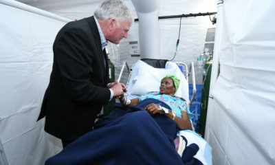Franklin Graham visits with a patient at the Emergency Field Hospital set up by Samaritan's Purse in the Bahamas.