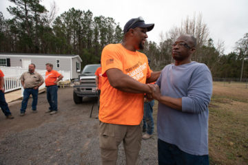 Marine Sergeant Robert Bogus speaks with homeowner and former Marine Chris Holmes during dedication of his new house.