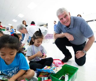 Samaritan's Purse President Franklin Graham joins children opening their shoebox gifts.