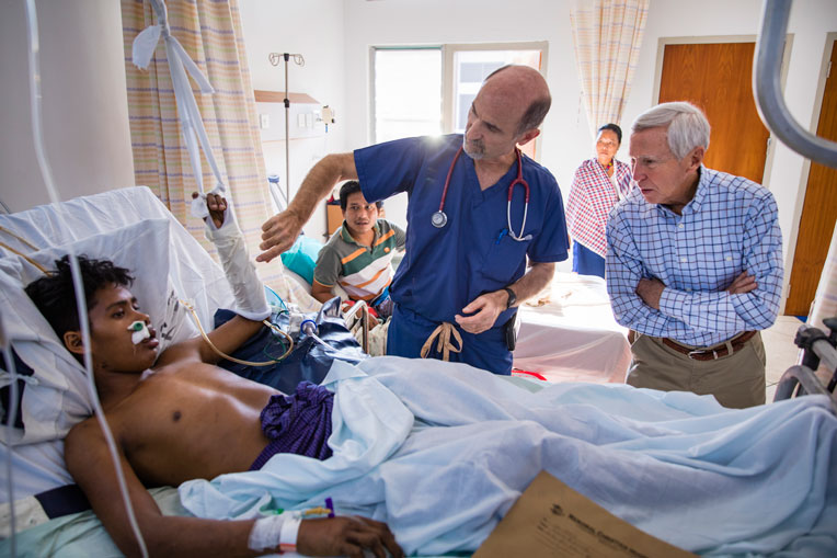 Dr. Stephen Kelley and Dr. Richard Furman meet with a patient in the newly constructed medical facility.