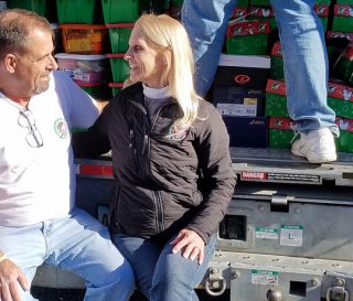 Volunteers Ed and Chris Duncan pause to celebrate how God worked to bring in truckloads of shoeboxes during National Collection Week.