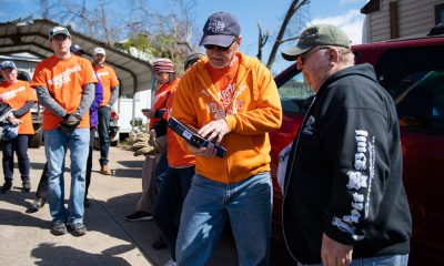 Samaritan’s Purse volunteers present Mike Worrell, right, with a Bible signed by those who worked on his property.