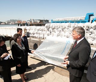 On behalf of Samaritan’s Purse, Franklin Graham delivers rolls of plastic sheeting to the city of Sinjiju, across the river from Dandong, China. The sheeting helped farmers protect seedlings from cold weather during early planting.