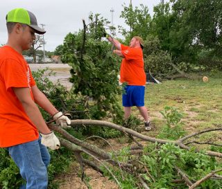 Samaritan's Purse volunteers clear limbs from a home in Bowie, Texas.