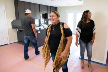 Francisca Castañeda walks through her new home for the first time after three years without a permanent place to live.