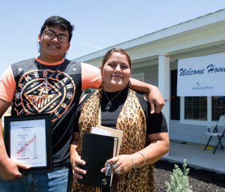 Francisca Castañeda and her son Jose celebrate moving into their new home in La Grange, Texas.