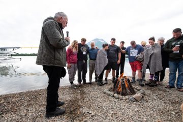 Franklin Graham prays with couples following the baptism ceremony in Lake Clark the final day of Week One.