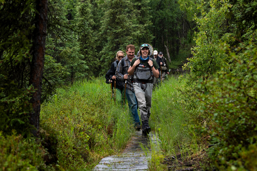 Our guides lead the way as couples hike the trail to Tanalian Falls in Lake Clark National Park.