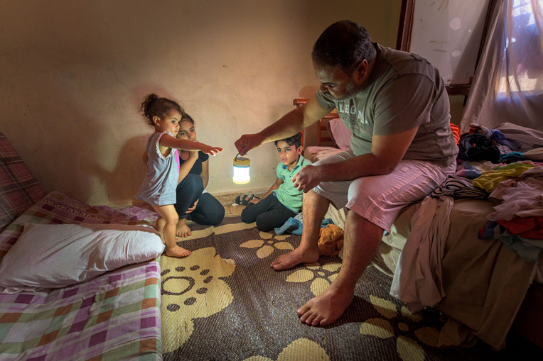Rahim brings light to the room where his children sleep. Hope, like light, has once again brightened their home in Beirut.