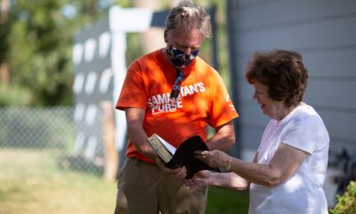 Volunteers presented homeowner Della Ramsey with a Billy Graham Study Bible signed by the team after clean up work was completed at her house.
