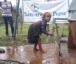 Children in rural Ethiopia enjoy water from a well restored by Samaritan's Purse.