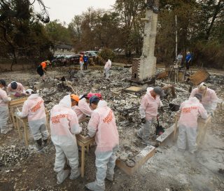 Volunteers are sifting through the ashes of homes burned by wildfires in Jackson County, Oregon.