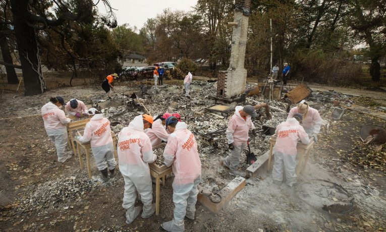 Volunteers are sifting through the ashes of homes burned by wildfires in Jackson County, Oregon.